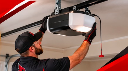 Red Crest technician working on a garage door opener head unit mounted at the ceiling